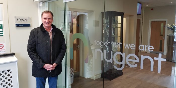 Phil Thompson in front of Nugent logo